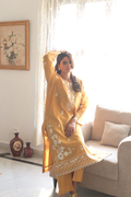 Scalloped hem of mustard semi formal outfit with embroidery